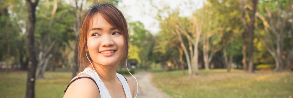 Woman in White Tank Top Standing Outdoor