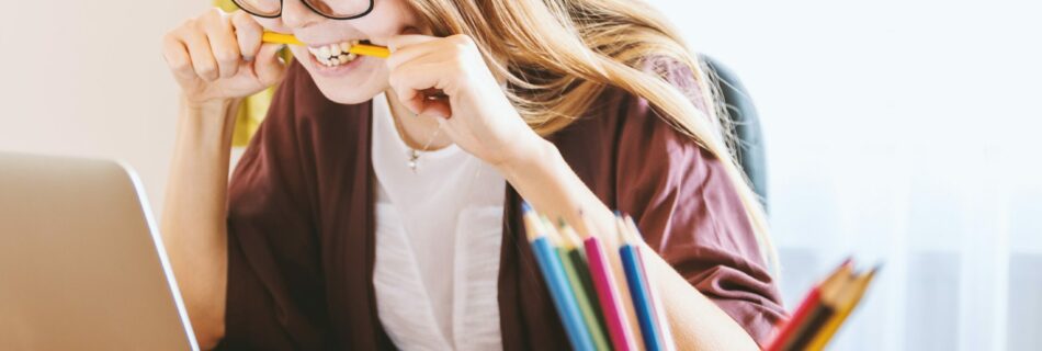 woman biting a pencil