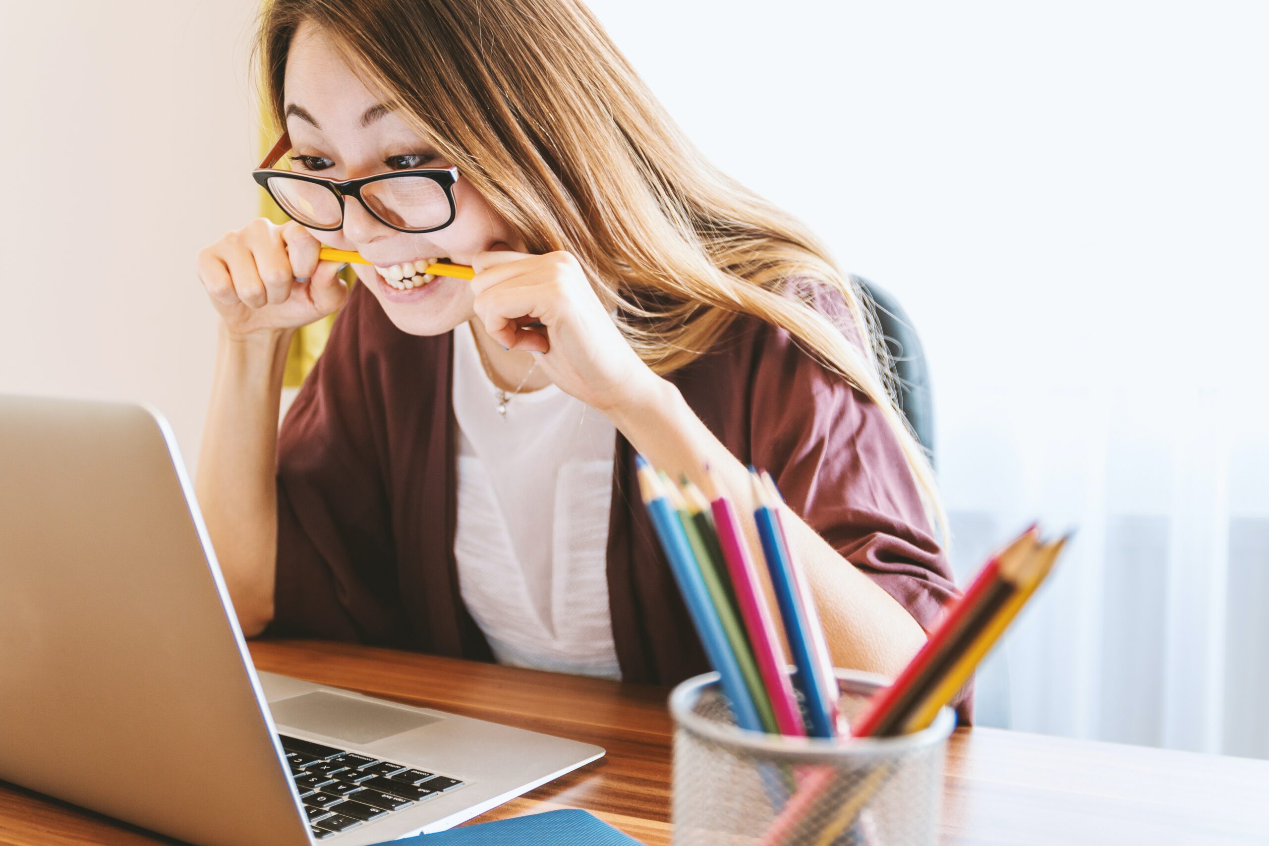 woman biting a pencil