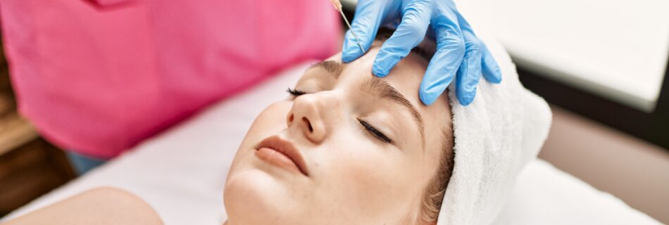 Doctor injecting botox on woman face for anti aging treatment at the clinic.